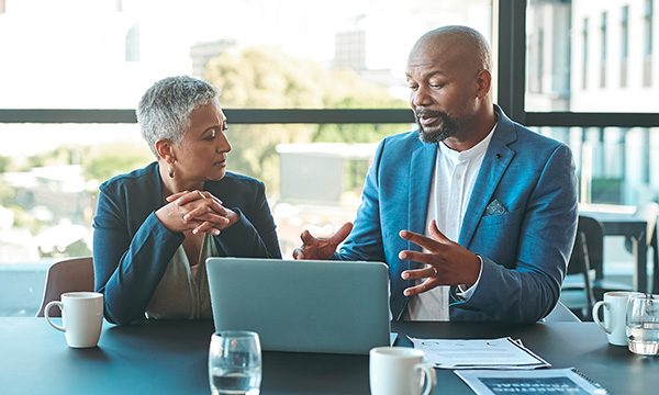 Two people collaborating looking at a computer screen